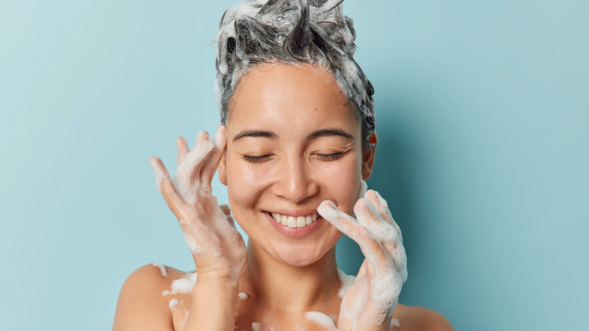 Woman shampooing her head