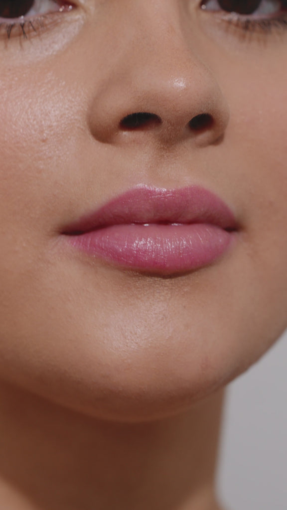 Girl applying  lip gloss